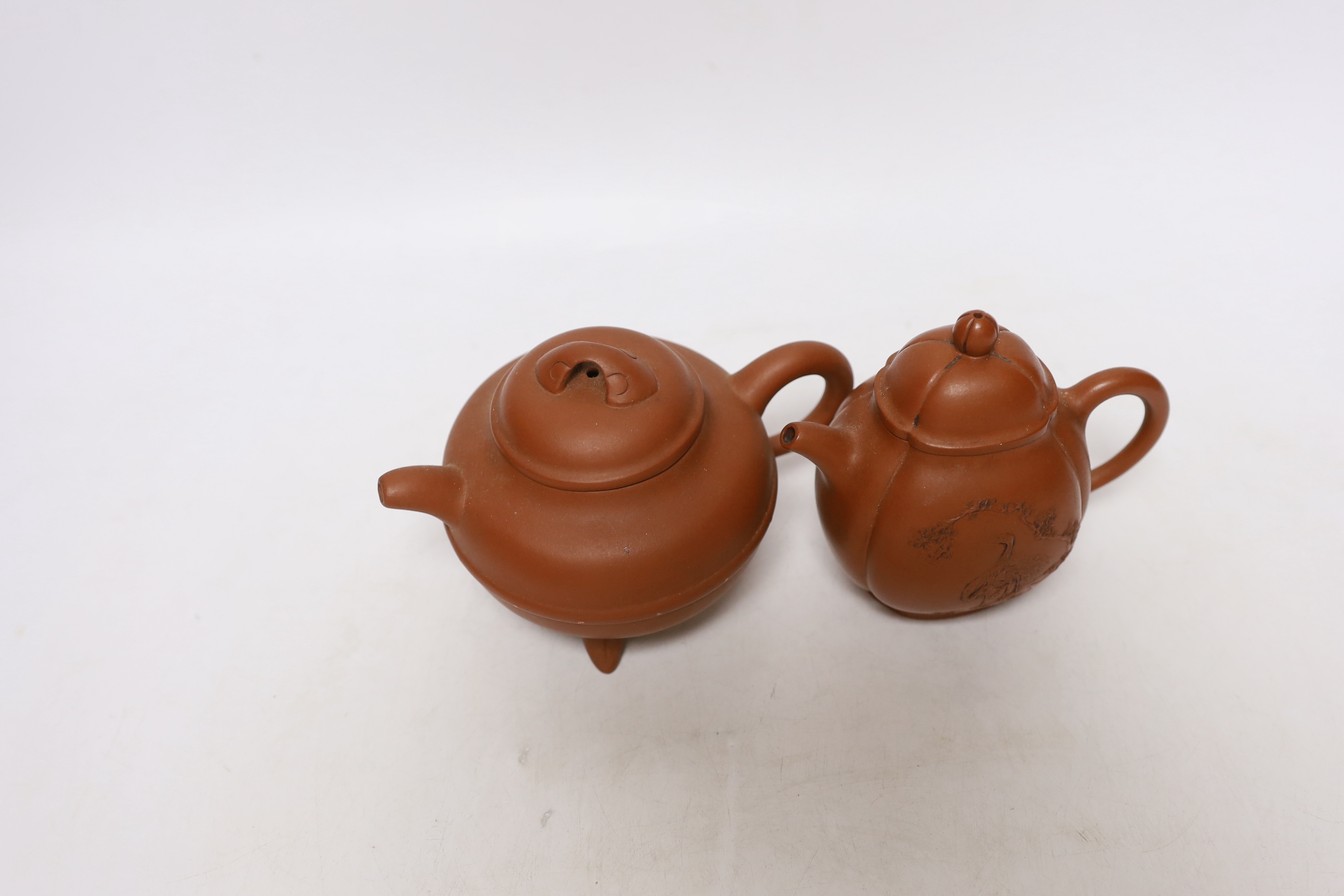 Four Chinese Yixing teapots, one slip decorated with a landscape, tallest 10.5cm